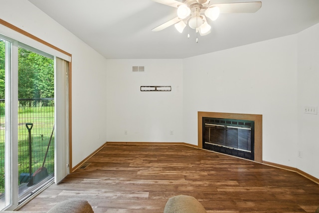26434 King Rd, Romulus, MI 48174 - unfurnished living room featuring a glass covered fireplace, wood finished floors, and a ceiling fan