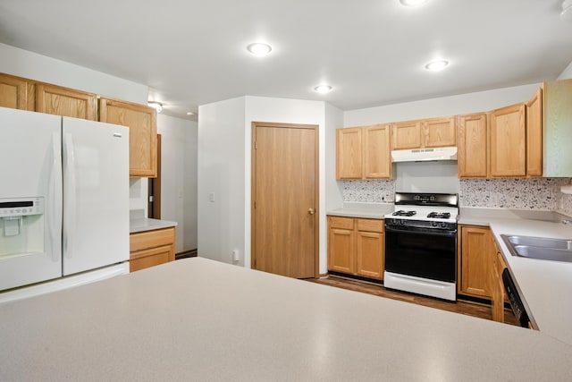 26434 King Rd, Romulus, MI 48174 - kitchen featuring white appliances, under cabinet range hood, light countertops, recessed lighting, and decorative backsplash