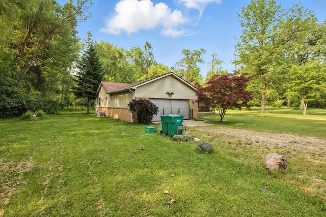 26434 King Rd, Romulus, MI 48174 - view of grassy yard with driveway and an attached garage