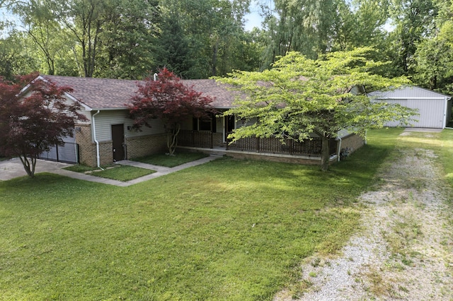 26434 King Rd, Romulus, MI 48174 - view of front of home with an attached garage, a front yard, brick siding, driveway, and a porch