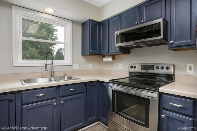 26855 King Rd, Brownstown, MI 48174 - kitchen with appliances with stainless steel finishes, blue cabinetry, and light countertops