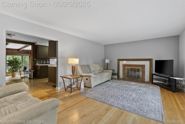 29866 Woodland Dr, Southfield, MI 48034 - living room with light wood-style flooring and a brick fireplace