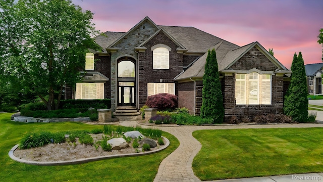 56343 Via Serbelloni, Macomb, MI 48042 - french country home with a front lawn and brick siding