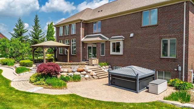 56343 Via Serbelloni, Macomb, MI 48042 - back of house with a gazebo, brick siding, and a patio area