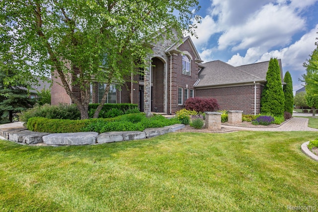 56343 Via Serbelloni, Macomb, MI 48042 - view of front facade with brick siding and a front yard