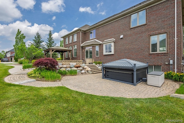 56343 Via Serbelloni, Macomb, MI 48042 - rear view of house with a gazebo, brick siding, a lawn, a patio area, and a hot tub