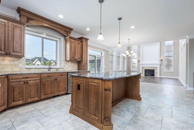 56343 Via Serbelloni, Macomb, MI 48042 - kitchen with stone tile floors, decorative backsplash, a center island, stone countertops, and stainless steel dishwasher