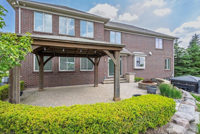 56343 Via Serbelloni, Macomb, MI 48042 - rear view of property with a gazebo, a patio area, brick siding, and a fire pit