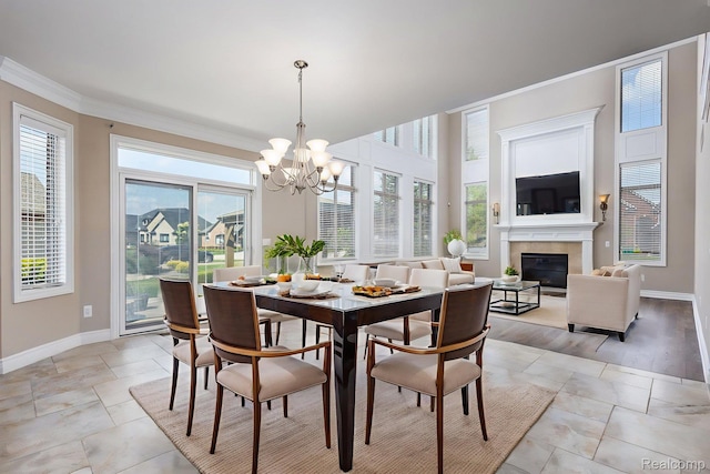 56343 Via Serbelloni, Macomb, MI 48042 - dining area featuring a glass covered fireplace, crown molding, and a chandelier