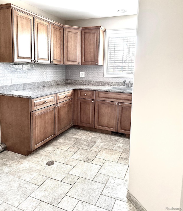 56343 Via Serbelloni, Macomb, MI 48042 - kitchen featuring decorative backsplash and stone tile flooring