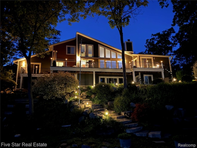 7025 Dandison Blvd, West Bloomfield, MI 48324 - rear view of house featuring a balcony, stairs, and a chimney