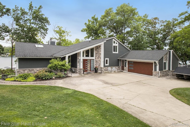 7025 Dandison Blvd, West Bloomfield, MI 48324 - mid-century inspired home with stone siding, a garage, driveway, and a chimney