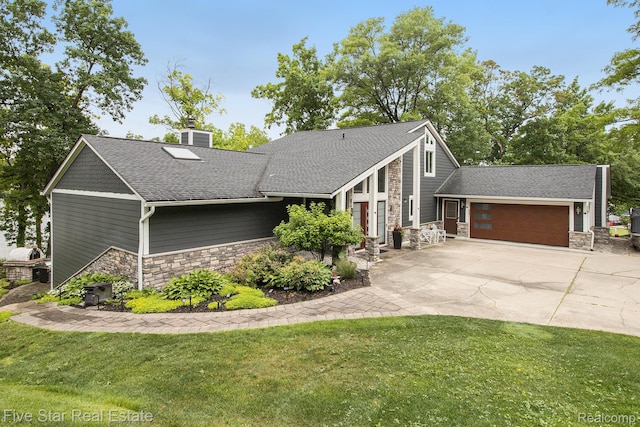 7025 Dandison Blvd, West Bloomfield, MI 48324 - mid-century modern home with stone siding, an attached garage, a front lawn, and a chimney