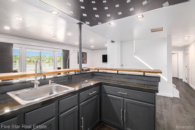 7025 Dandison Blvd, West Bloomfield, MI 48324 - kitchen with dark wood-style flooring, dark countertops, a water view, and recessed lighting