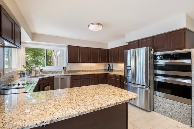 7025 Dandison Blvd, West Bloomfield, MI 48324 - kitchen with appliances with stainless steel finishes, dark brown cabinets, and light stone countertops