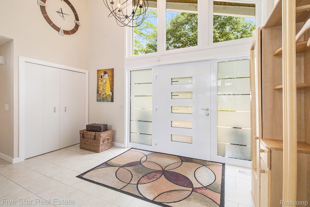 7025 Dandison Blvd, West Bloomfield, MI 48324 - entrance foyer with a towering ceiling, light tile patterned floors, and a chandelier