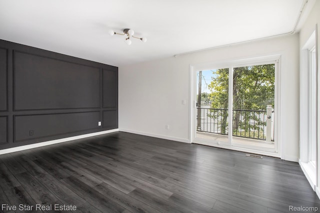 7025 Dandison Blvd, West Bloomfield, MI 48324 - unfurnished room with dark wood-type flooring and a chandelier