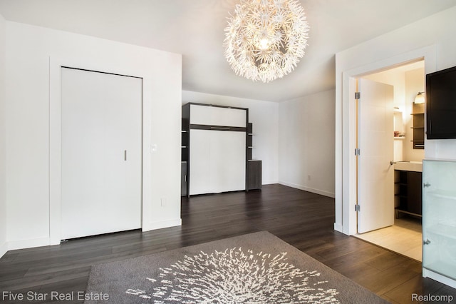 7025 Dandison Blvd, West Bloomfield, MI 48324 - unfurnished bedroom featuring wood finished floors and a chandelier