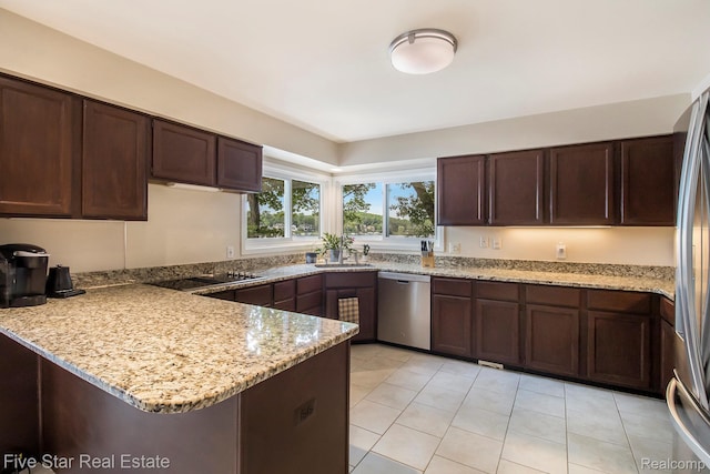 7025 Dandison Blvd, West Bloomfield, MI 48324 - kitchen with stainless steel appliances, a peninsula, light tile patterned floors, light stone counters, and dark brown cabinetry