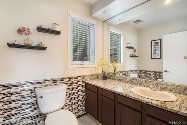 7025 Dandison Blvd, West Bloomfield, MI 48324 - bathroom with tile walls, vanity, wainscoting, and tile patterned floors