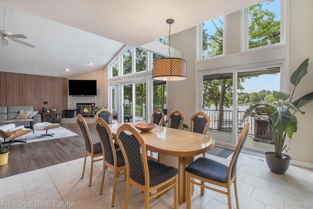 7025 Dandison Blvd, West Bloomfield, MI 48324 - tiled dining area featuring high vaulted ceiling, plenty of natural light, ceiling fan, a glass covered fireplace, and recessed lighting