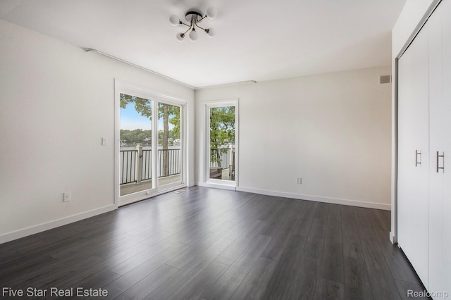 7025 Dandison Blvd, West Bloomfield, MI 48324 - empty room featuring dark wood finished floors and a chandelier