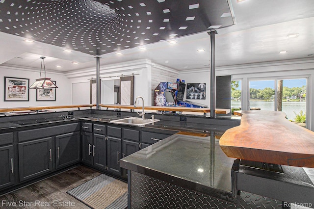 7025 Dandison Blvd, West Bloomfield, MI 48324 - kitchen featuring dark wood-style flooring, dark countertops, dark cabinetry, a water view, and ornamental molding