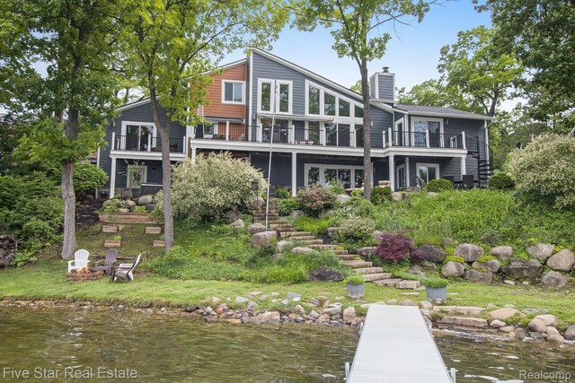 7025 Dandison Blvd, West Bloomfield, MI 48324 - rear view of house with stairs, a chimney, a balcony, and a water view