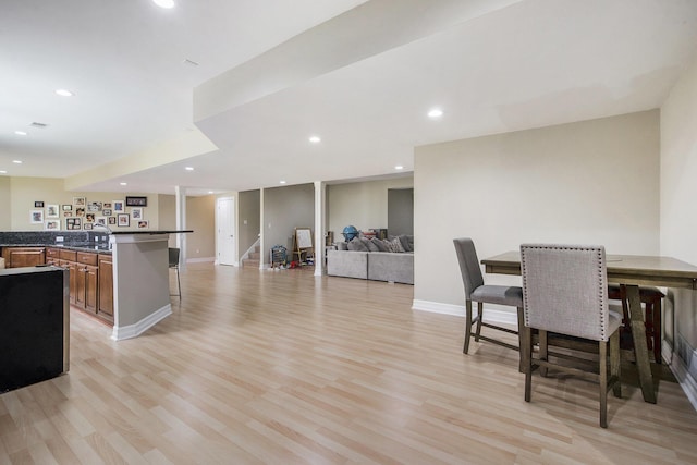 6577 Heron Ct, Ann Arbor, MI 48103 - dining space featuring light wood-style flooring, bar area, recessed lighting, and stairway