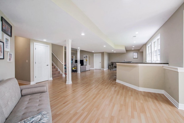 6577 Heron Ct, Ann Arbor, MI 48103 - unfurnished living room with light wood-style flooring, stairway, and recessed lighting
