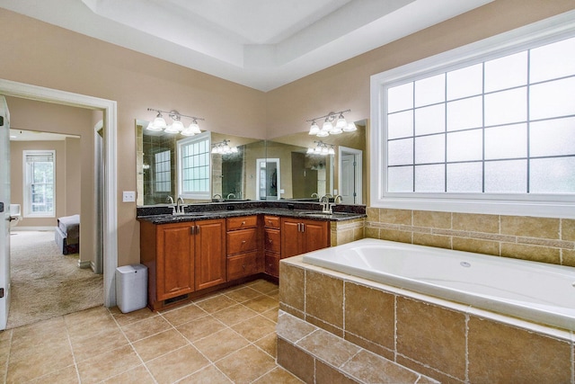 6577 Heron Ct, Ann Arbor, MI 48103 - ensuite bathroom featuring double vanity, a bath, a raised ceiling, and tile patterned floors