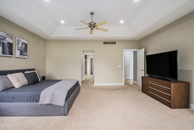 6577 Heron Ct, Ann Arbor, MI 48103 - bedroom featuring a tray ceiling, light colored carpet, recessed lighting, and a ceiling fan
