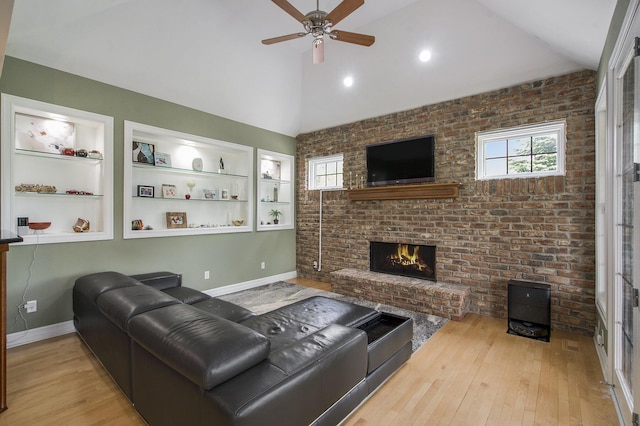 6577 Heron Ct, Ann Arbor, MI 48103 - living area featuring lofted ceiling, wood finished floors, a brick fireplace, and ceiling fan