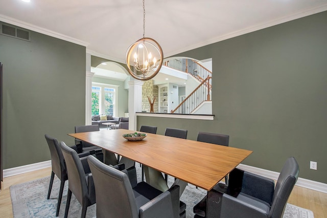 6577 Heron Ct, Ann Arbor, MI 48103 - dining area featuring ornate columns, light wood-style flooring, a chandelier, crown molding, and stairway