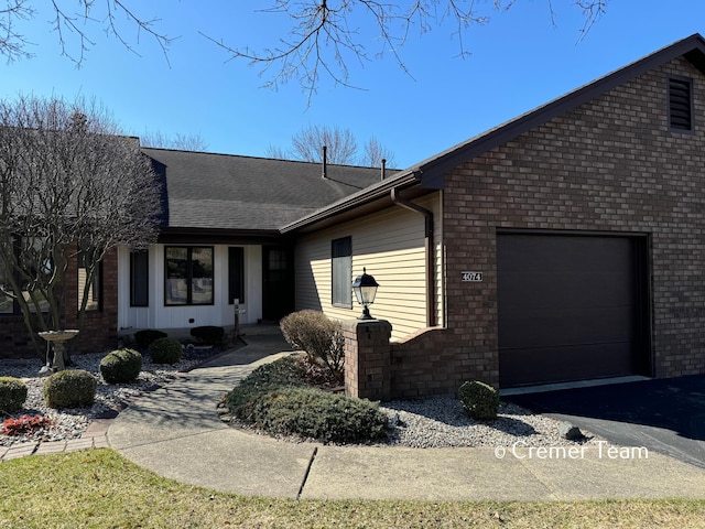 4074 Grandview Ter SW, Grandville, MI 49418 - view of front of property featuring an attached garage, brick siding, and a shingled roof