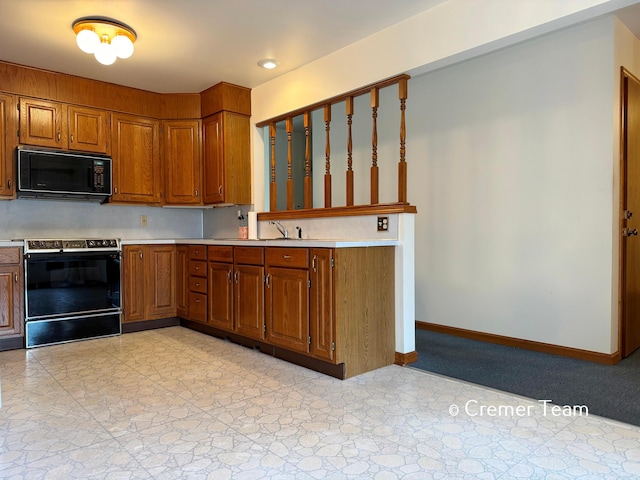 4074 Grandview Ter SW, Grandville, MI 49418 - kitchen featuring black microwave, electric range, brown cabinetry, light countertops, and recessed lighting
