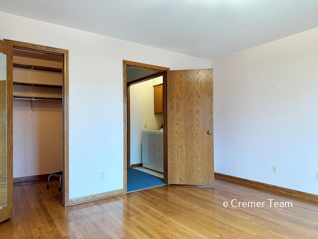 4074 Grandview Ter SW, Grandville, MI 49418 - unfurnished bedroom with washer / dryer, light wood-style floors, a closet, a spacious closet, and ensuite bathroom