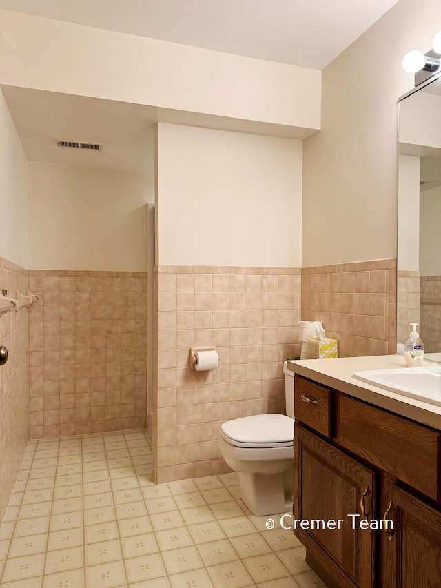 4074 Grandview Ter SW, Grandville, MI 49418 - bathroom featuring tile walls, wainscoting, vanity, and a shower