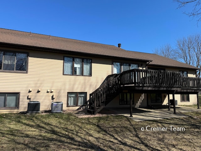 4074 Grandview Ter SW, Grandville, MI 49418 - rear view of property featuring a wooden deck, stairs, a lawn, and a patio area