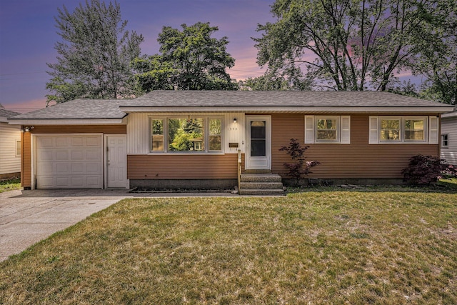 1553 Greenwich Rd, Muskegon, MI 49441 - ranch-style home featuring a garage, a yard, concrete driveway, and entry steps