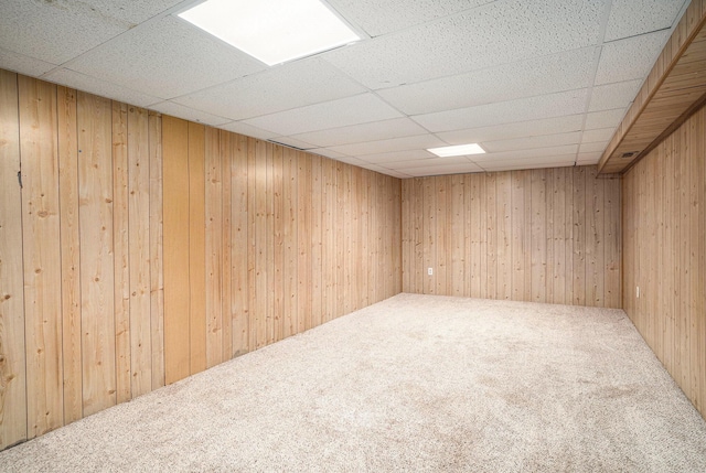 1553 Greenwich Rd, Muskegon, MI 49441 - unfurnished room with carpet floors, wooden walls, and a drop ceiling