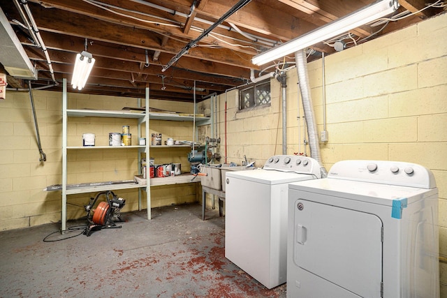 1553 Greenwich Rd, Muskegon, MI 49441 - laundry room featuring washing machine and dryer and concrete block wall