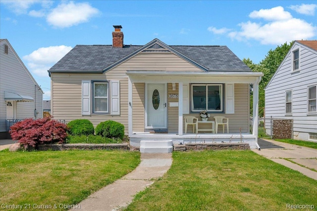 1678 Merrill Ave, Lincoln Park, MI 48146 - bungalow-style house featuring a porch, a front yard, a chimney, and roof with shingles