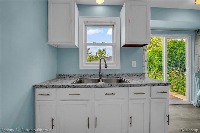 1678 Merrill Ave, Lincoln Park, MI 48146 - kitchen featuring white cabinetry and light stone countertops