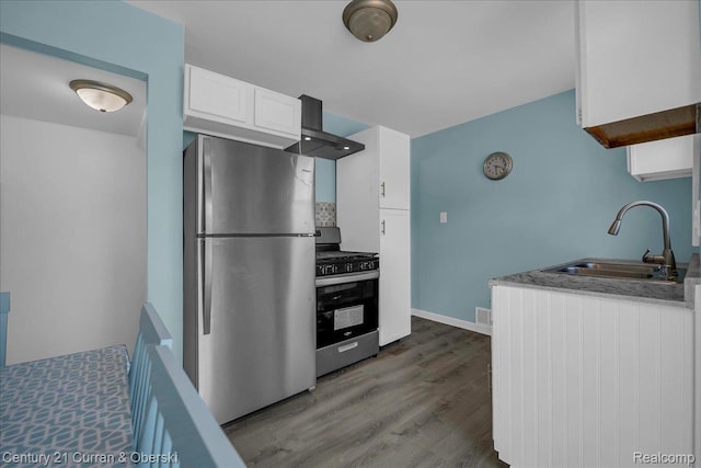 1678 Merrill Ave, Lincoln Park, MI 48146 - kitchen with stainless steel appliances, wall chimney exhaust hood, white cabinetry, dark wood-style floors, and backsplash