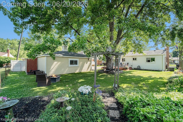 12141 Danforth Dr, Sterling Heights, MI 48312 - view of yard featuring a fire pit, a pergola, and an outdoor structure