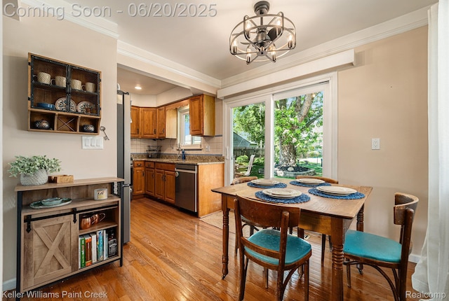 12141 Danforth Dr, Sterling Heights, MI 48312 - kitchen with dishwasher, a chandelier, brown cabinets, light wood finished floors, and decorative backsplash