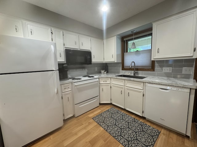 7337 Pine Grove Dr, Jenison, MI 49428 - kitchen with white appliances, white cabinetry, backsplash, light wood-type flooring, and hanging light fixtures