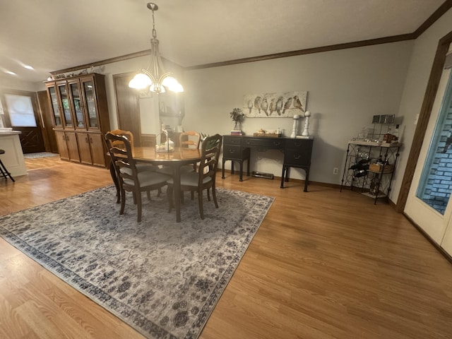 7337 Pine Grove Dr, Jenison, MI 49428 - dining area with ornamental molding, a chandelier, and light wood-type flooring