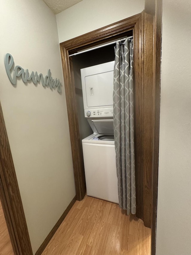 7337 Pine Grove Dr, Jenison, MI 49428 - laundry area with stacked washer / dryer and light wood-type flooring